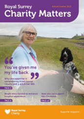 Image showing the front cover of Royal Surrey Charity Matters magazine - with a woman and dog in the countryside. 
