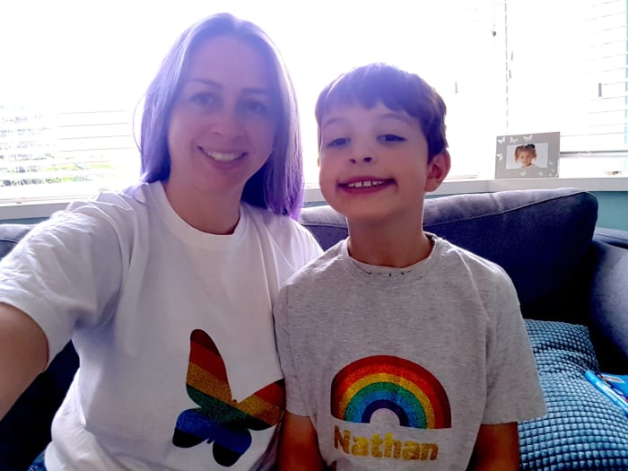 A mother and her son wearing rainbow t-shirts